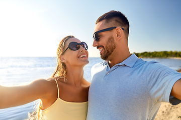 Image showing happy couple taking selfie on summer beach