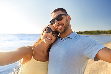 Image showing happy couple taking selfie on summer beach