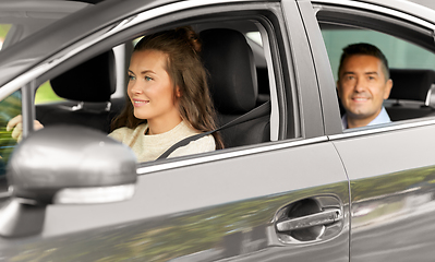 Image showing female driver driving car with male passenger