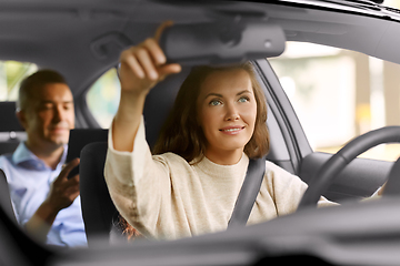 Image showing female driver driving car with male passenger