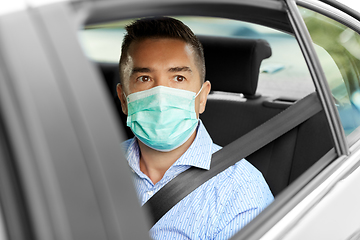 Image showing man or male passenger wearing mask in car