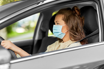 Image showing woman or female driver in mask driving car in city