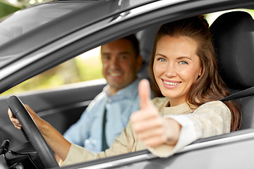 Image showing car driving instructor and woman showing thumbs up