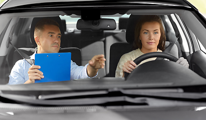 Image showing car driving school instructor and young driver