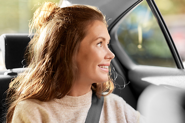 Image showing happy smiling woman or female passenger in car