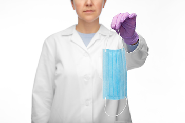 Image showing female doctor in gloves showing medical mask