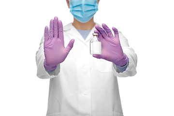 Image showing close up of doctor with syringe shows stop gesture