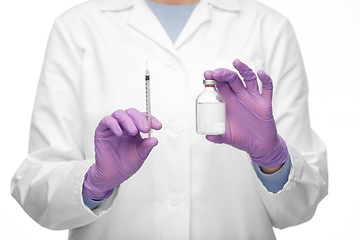 Image showing close up of doctor with medicine and syringe