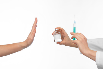 Image showing hand with medicine and showing stop gesture