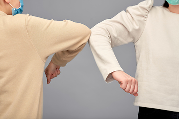 Image showing close up of women making elbow bump gesture