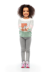 Image showing smiling african american girl holding house model