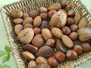 Image showing Mix of different types nuts in wicker dish