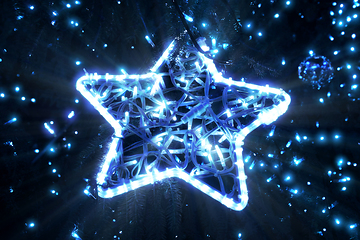 Image showing Bright beautiful glowing star on a Christmas tree in the evening