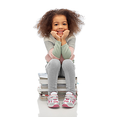 Image showing smiling girl with magazines sorting paper waste