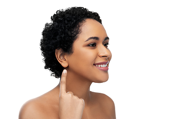 Image showing smiling african american woman showing her ear