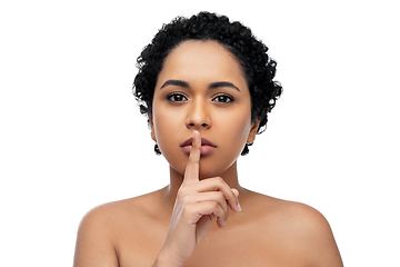 Image showing young african american woman with finger on lips