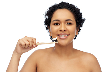 Image showing smiling woman with toothbrush cleaning teeth