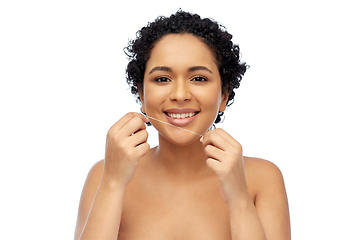 Image showing african woman cleaning teeth with dental floss