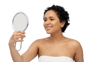 Image showing smiling african american woman looking to mirror