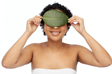 Image showing portrait of african american woman with green leaf