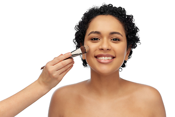 Image showing happy woman and hand of make up artist with brush