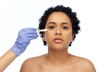 Image showing african american woman and hand with scalpel knife