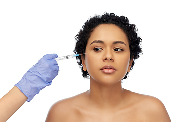 Image showing face of african woman and hand with syringe