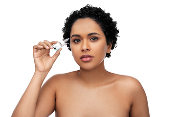 Image showing young african american woman with eye drops