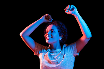 Image showing african american woman dancing over neon lights