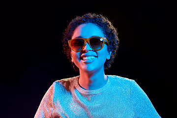 Image showing african woman in sunglasses over neon lights