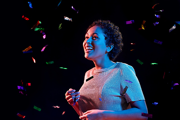 Image showing african woman under confetti at nightclub party