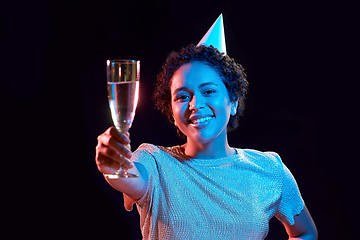 Image showing african woman in party cap with glass of champagne