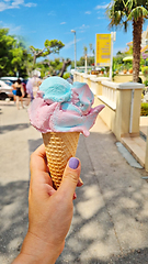 Image showing Gelato ice cream cone held up to the hot summer city