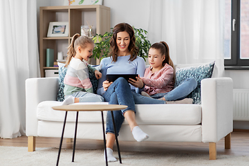 Image showing happy mother and daughters with tablet pc at home