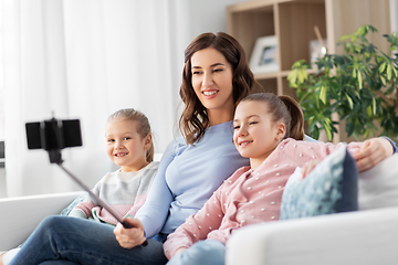 Image showing happy family taking selfie by smartphone at home