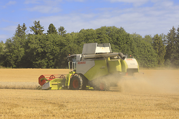 Image showing Harvesting Wheat with Claas Tucano 570 Combine Harvester