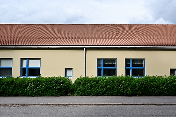 Image showing front view of a building with a tiled roof