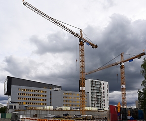 Image showing two cranes at the construction site 