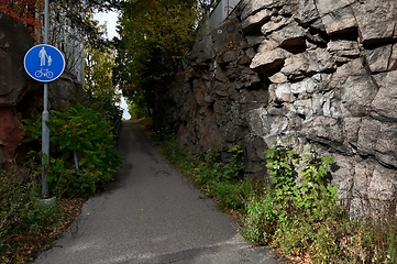 Image showing walking and cycling path next to a rock in Finland