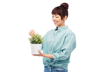 Image showing happy smiling asian woman holding flower in pot