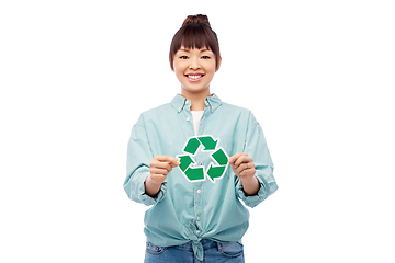 Image showing smiling asian woman holding green recycling sign