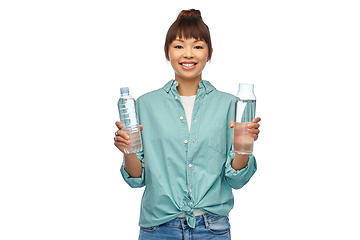 Image showing asian woman with plastic and glass bottle of water