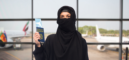 Image showing muslim woman with air ticket and immunity passport