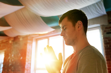 Image showing close up of man meditating at yoga studio