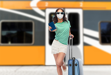 Image showing teenage girl in mask with travel bag and passport