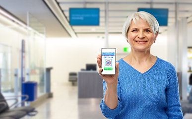 Image showing old woman with certificate of vaccination on phone