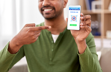 Image showing man with certificate of vaccination on smartphone