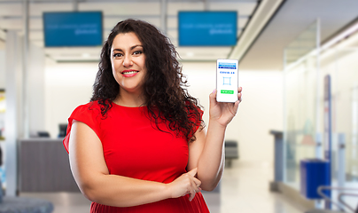 Image showing woman with certificate of vaccination on phone