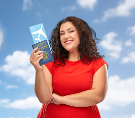 Image showing happy woman with immunity passport and air ticket