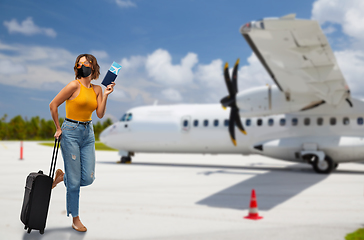 Image showing woman in mask with bag and ticket over plain